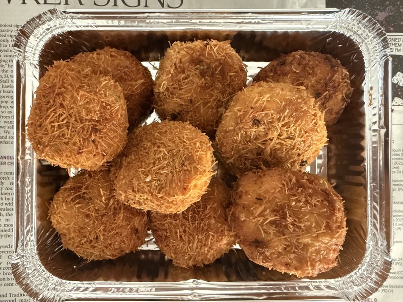 Chicken Reshmi Kabab: eight golden-brown, shredded-crust fried patties arranged in a silver foil tray, with no visible garnishes or accompaniments.